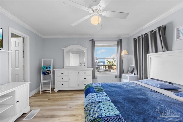 bedroom featuring ceiling fan, ornamental molding, and light hardwood / wood-style flooring