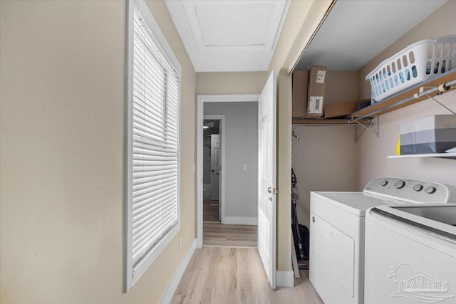 washroom featuring washer and dryer and light hardwood / wood-style floors