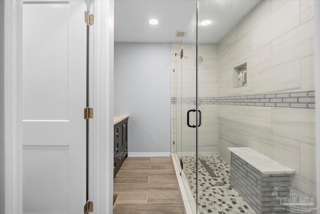 bathroom with vanity and a shower with shower door