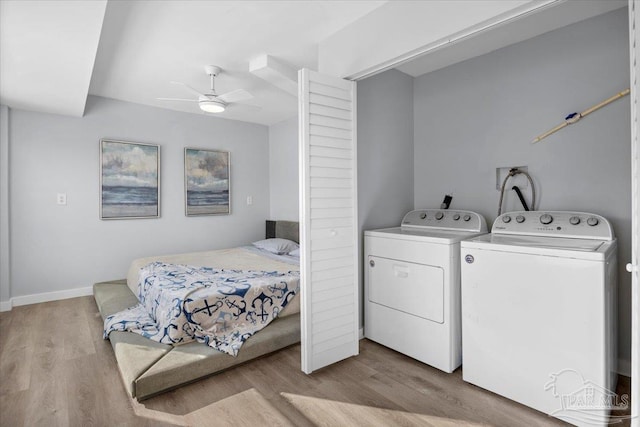 laundry area with ceiling fan, light hardwood / wood-style floors, and independent washer and dryer