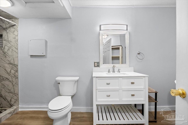 bathroom featuring a shower, vanity, hardwood / wood-style flooring, and toilet