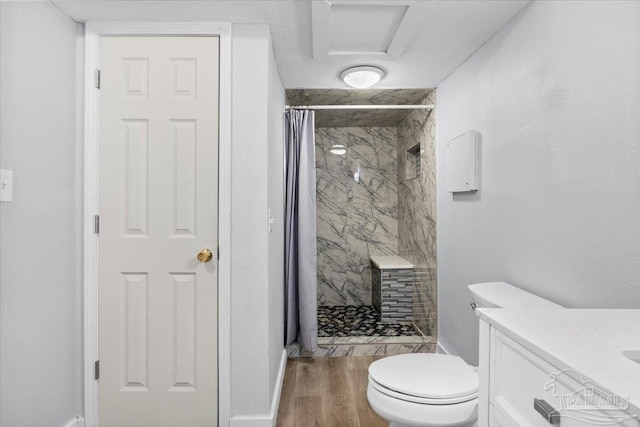 bathroom featuring a shower with curtain, hardwood / wood-style floors, vanity, and toilet