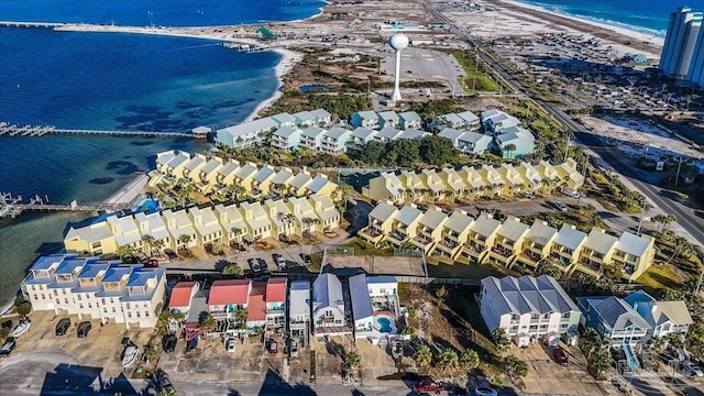 birds eye view of property featuring a water view and a beach view