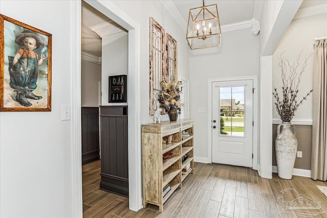3160 Mountain Laurel Trl, Cantonment, FL 32533 - foyer entrance with crown molding, a chandelier, and wood finished floors