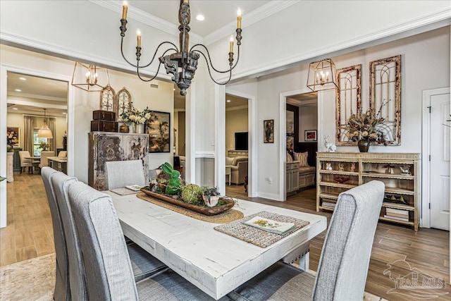3160 Mountain Laurel Trl, Cantonment, FL 32533 - dining area with a chandelier, crown molding, wood finished floors, and recessed lighting