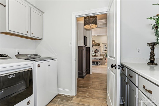 3160 Mountain Laurel Trl, Cantonment, FL 32533 - laundry room featuring washer and dryer, cabinet space, and wood finish floors