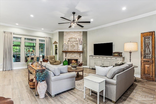 3160 Mountain Laurel Trl, Cantonment, FL 32533 - living room with a ceiling fan, recessed lighting, a stone fireplace, ornamental molding, and light wood finished floors
