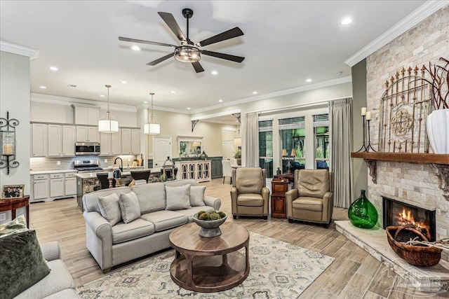 3160 Mountain Laurel Trl, Cantonment, FL 32533 - living area featuring ceiling fan, light wood finished floors, a fireplace, recessed lighting, and ornamental molding