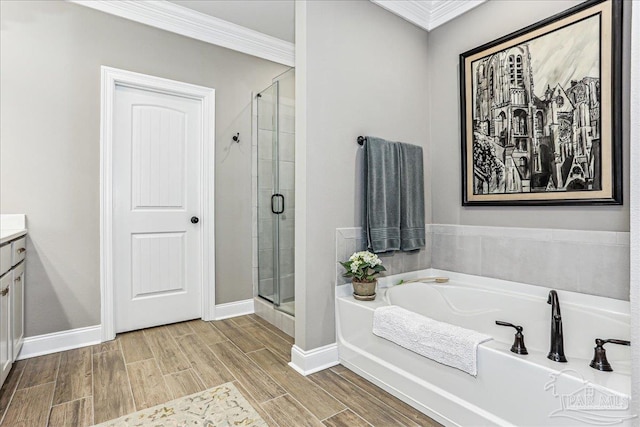 3160 Mountain Laurel Trl, Cantonment, FL 32533 - bathroom with a garden tub, a stall shower, vanity, ornamental molding, and wood tiled floors