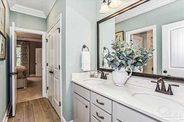 3160 Mountain Laurel Trl, Cantonment, FL 32533 - bathroom with ornamental molding, double vanity, and wood finish floors