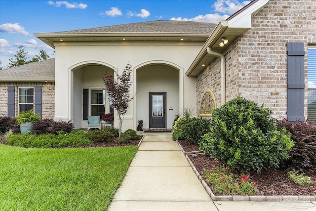3160 Mountain Laurel Trl, Cantonment, FL 32533 - entrance to property featuring brick siding, stucco siding, roof with shingles, and a lawn