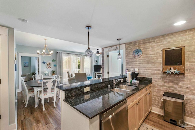 kitchen featuring dishwasher, hardwood / wood-style flooring, and hanging light fixtures