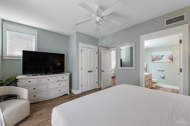 bedroom with connected bathroom, ceiling fan, and hardwood / wood-style floors