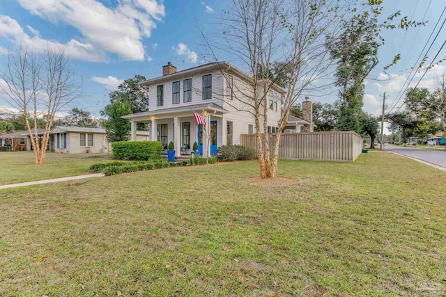 view of front of home with a porch and a front lawn