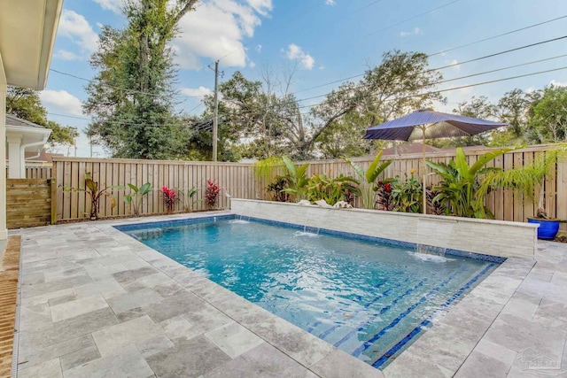 view of swimming pool with pool water feature and a patio