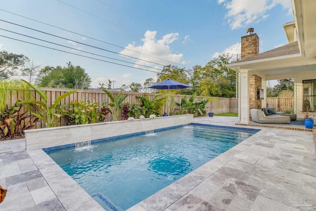 view of swimming pool with outdoor lounge area, pool water feature, and a patio