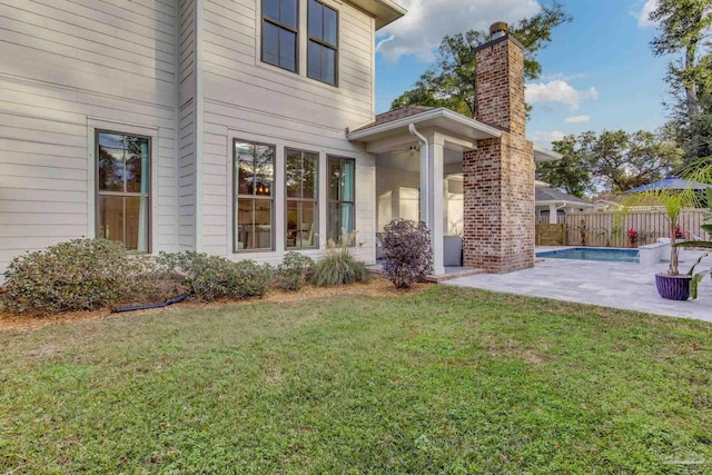 back of house featuring a patio area and a yard