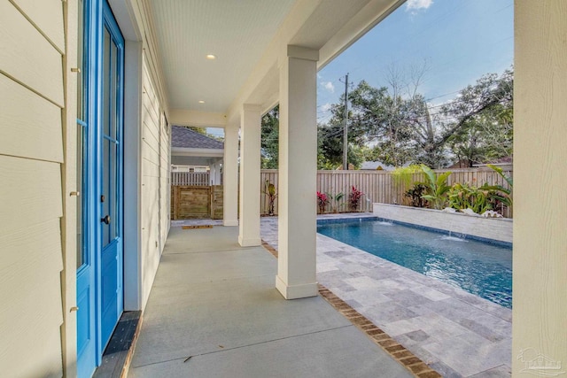 view of swimming pool with a patio area and pool water feature