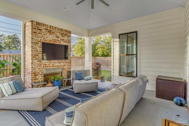 view of patio / terrace with ceiling fan and an outdoor brick fireplace