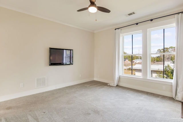 empty room with ceiling fan, ornamental molding, and light carpet