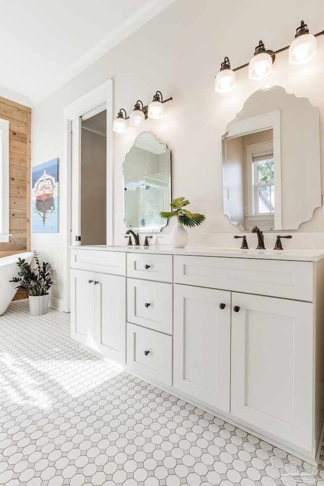 bathroom with a tub, wooden walls, crown molding, and vanity