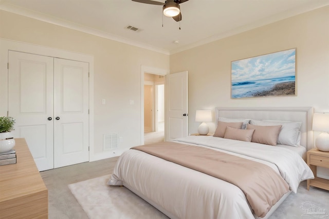 carpeted bedroom featuring a closet, ceiling fan, and ornamental molding