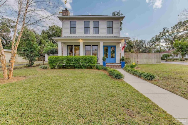 view of front facade with french doors and a front lawn