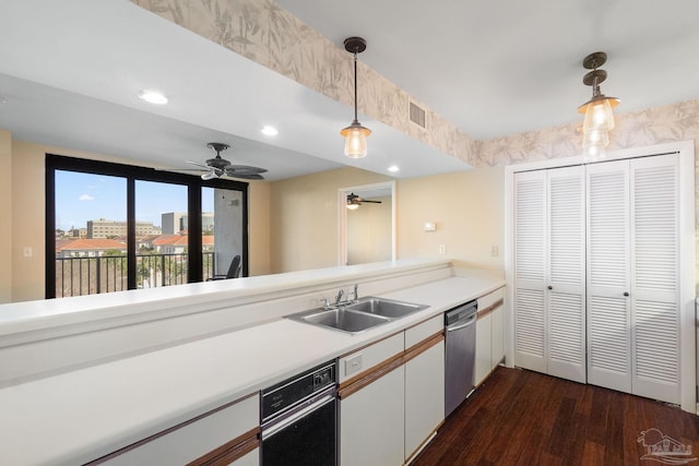 kitchen with sink, white cabinetry, pendant lighting, dark hardwood / wood-style floors, and stainless steel dishwasher