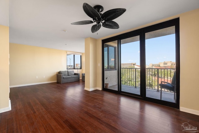 spare room with dark wood-type flooring and floor to ceiling windows