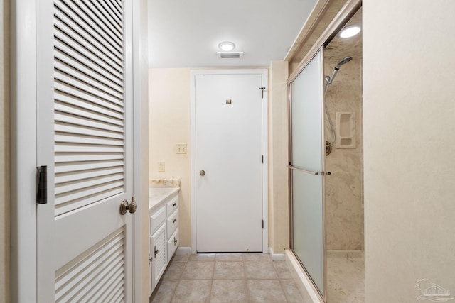 bathroom with vanity, tile patterned flooring, and an enclosed shower