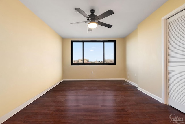 empty room with dark hardwood / wood-style floors and ceiling fan