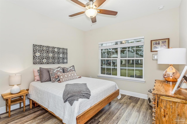 bedroom with ceiling fan and dark hardwood / wood-style floors