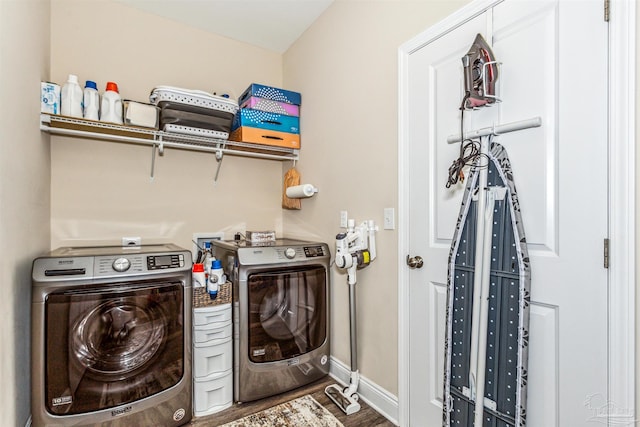 laundry area with hardwood / wood-style flooring and washer and clothes dryer