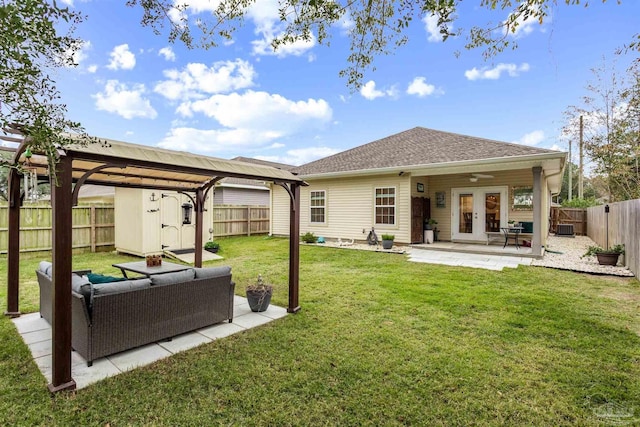 back of property featuring outdoor lounge area, a lawn, french doors, a shed, and a patio area