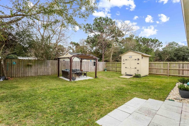 view of yard featuring a gazebo, an outdoor living space, a shed, and a patio area