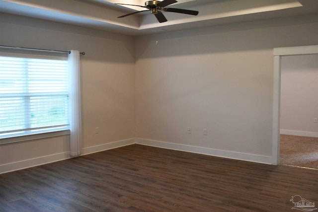 empty room featuring ceiling fan and dark wood-type flooring