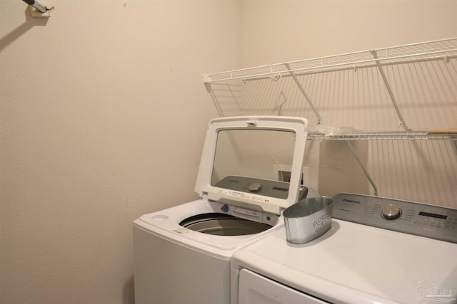 clothes washing area with independent washer and dryer