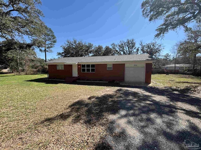 ranch-style home featuring a garage, a front yard, and driveway