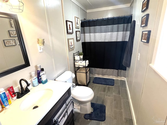 bathroom featuring vanity, toilet, a shower with curtain, and wood finish floors