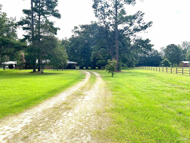 view of road with a rural view and driveway