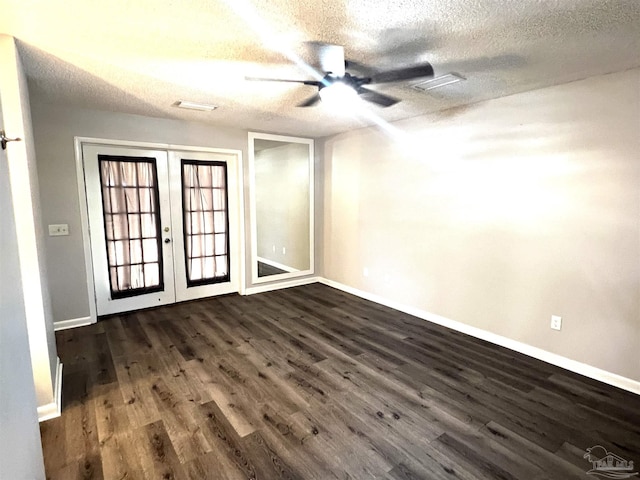 unfurnished room featuring french doors, a textured ceiling, ceiling fan, and dark wood-style flooring