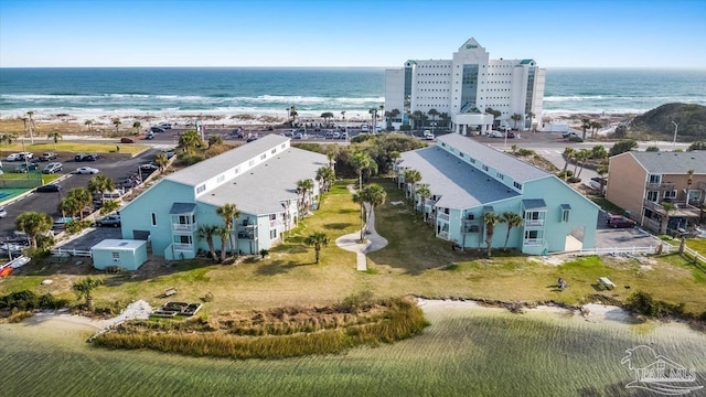 bird's eye view featuring a water view and a beach view