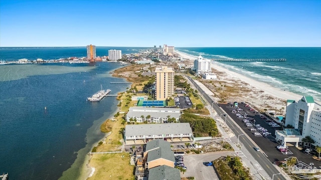 drone / aerial view featuring a water view and a beach view