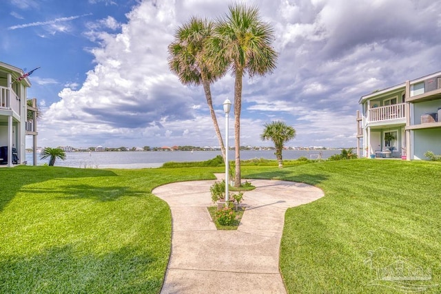 view of yard featuring a water view and a balcony