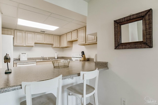 kitchen featuring a drop ceiling, stove, and a breakfast bar