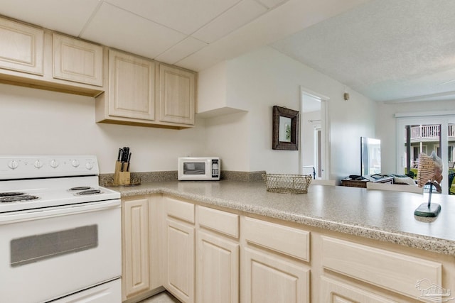 kitchen featuring white appliances, kitchen peninsula, and light brown cabinetry