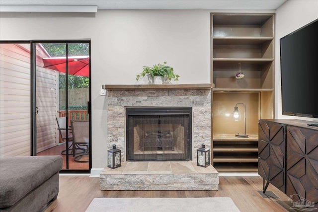 interior space featuring wood-type flooring and a fireplace