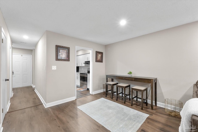 interior space with a textured ceiling and dark hardwood / wood-style flooring