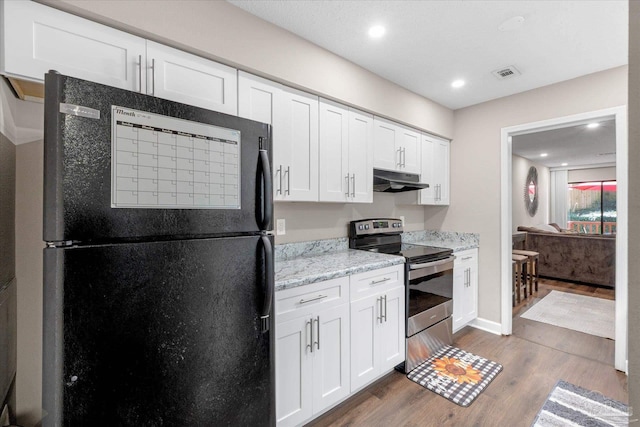 kitchen featuring black fridge, white cabinets, electric range, light stone countertops, and dark hardwood / wood-style flooring