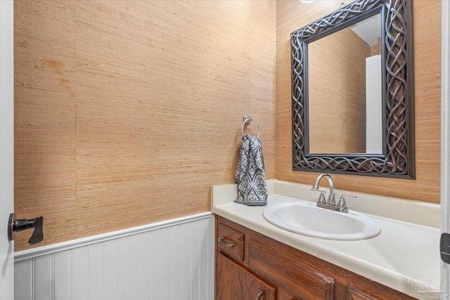 bathroom with wood walls and vanity